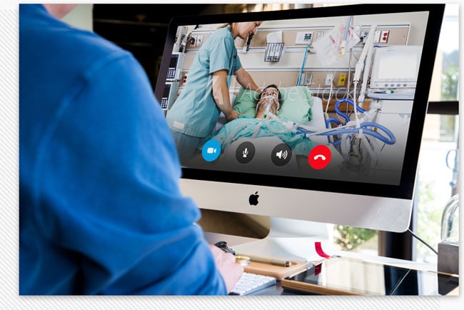 Doctor Remotely Monitoring ICU Patient Off-Site